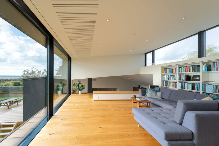 a living room with a couch and a bookcase