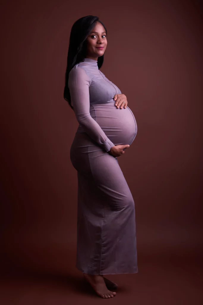 a pregnant woman in a long dress